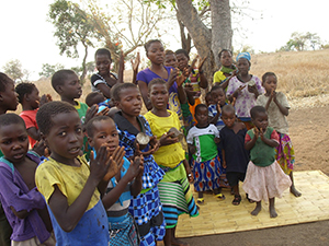 Women and children in Cado sing.