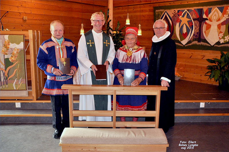 Two Sami congregants pose with the new edition of the New Testament along with The Lutheran Church in Norway's Provisional Bishop Torkild Masvie (second from left) and Rev. Olav Lyngmo (far right).